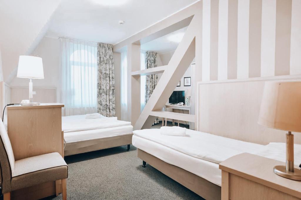 Postel nebo postele na pokoji v ubytování Hotel Amalia