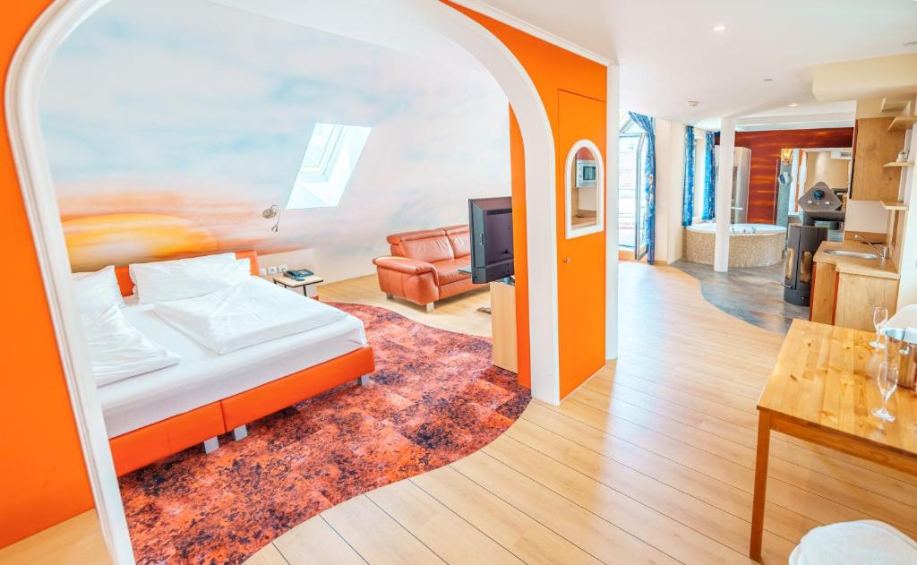 a bedroom with a bed and a mirror at Penthouse mit Whirlpool, Sauna, Dachterrasse und Schwedenofen, air-condition in Altötting