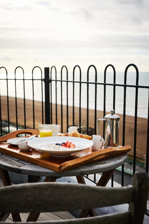 a table with a plate of food on the beach at Drakes Hotel in Brighton & Hove