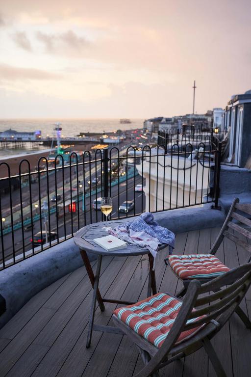 a patio with two chairs and a table on a balcony at Drakes Hotel in Brighton & Hove