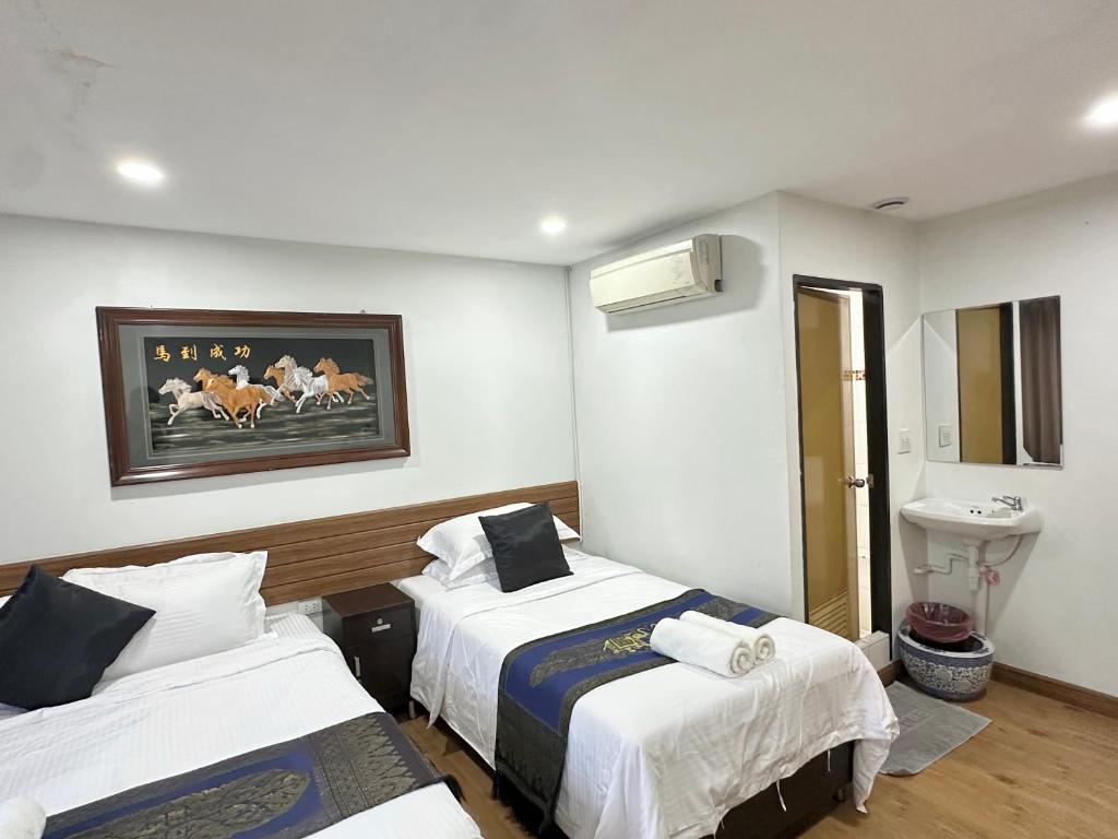 Postel nebo postele na pokoji v ubytování Longzhu Guesthouse