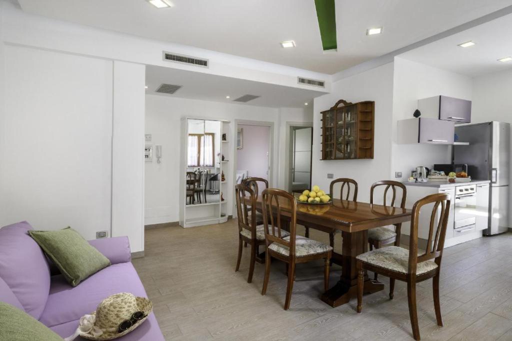 a living room with a table and a purple couch at Rose Sorrento House in Sorrento