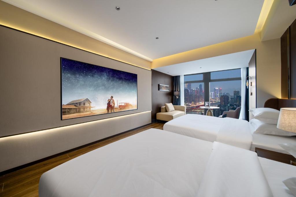Postel nebo postele na pokoji v ubytování Chongqing Junsheng Yunduan Riverview Hotel