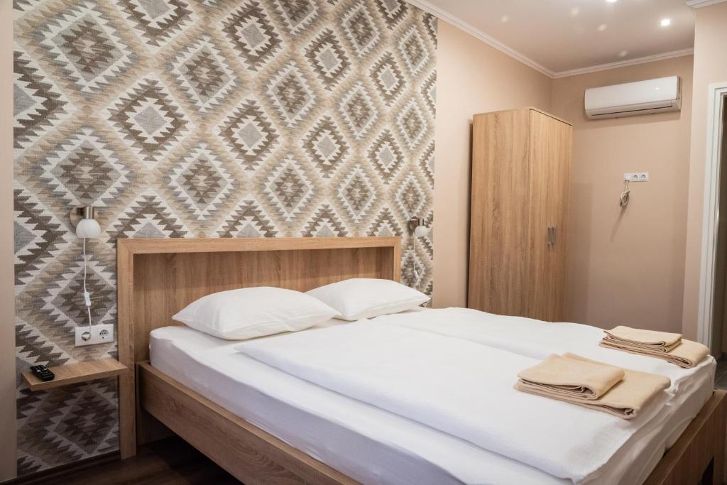 Postel nebo postele na pokoji v ubytování Gesztenye Apartman