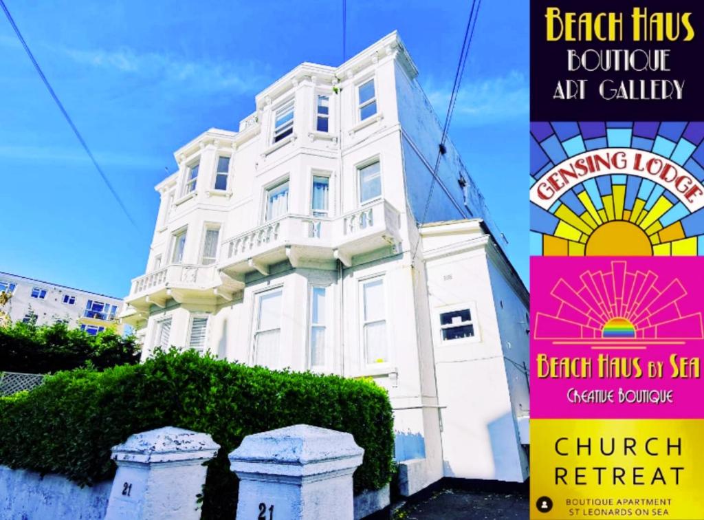 a white building with a sign in front of it at Church Retreat - A Magnificent Seaside Apartment-Award Winning in Hastings