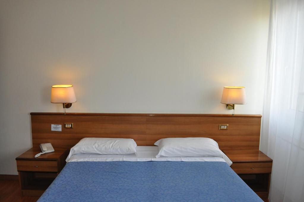 Postel nebo postele na pokoji v ubytování Hotel Igea