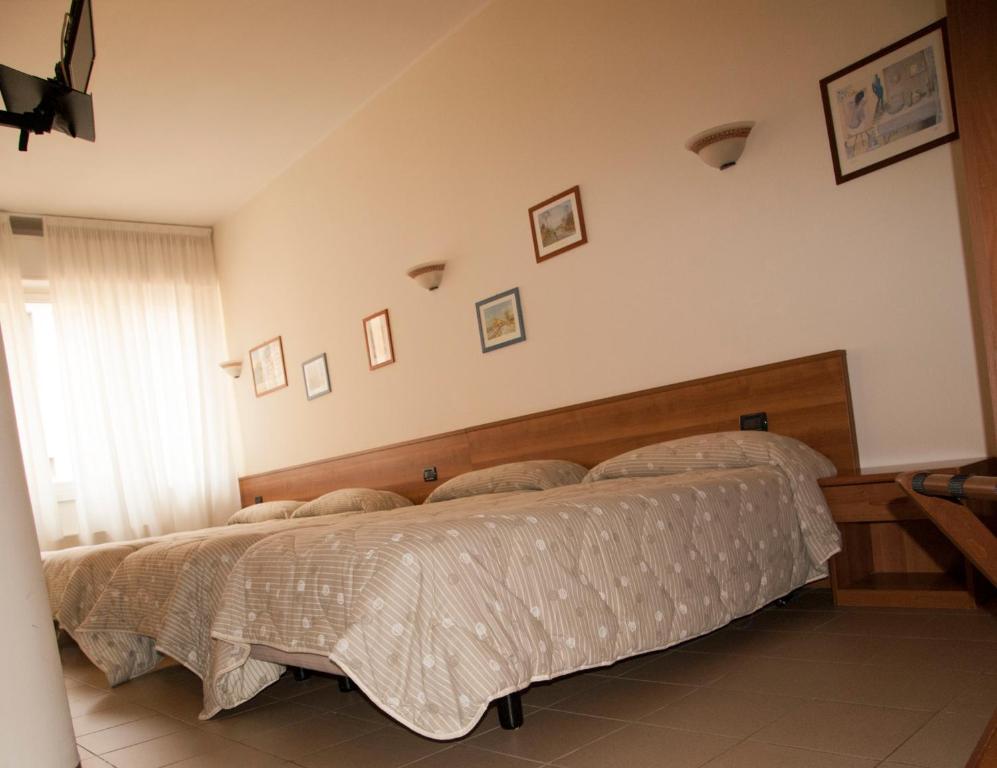 Postel nebo postele na pokoji v ubytování Hotel Marinoni