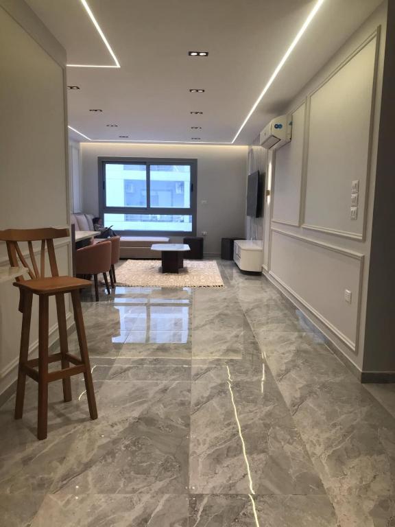 a living room with a stone floor and a large window at Luxury Furnished Condo in Egypt in Cairo