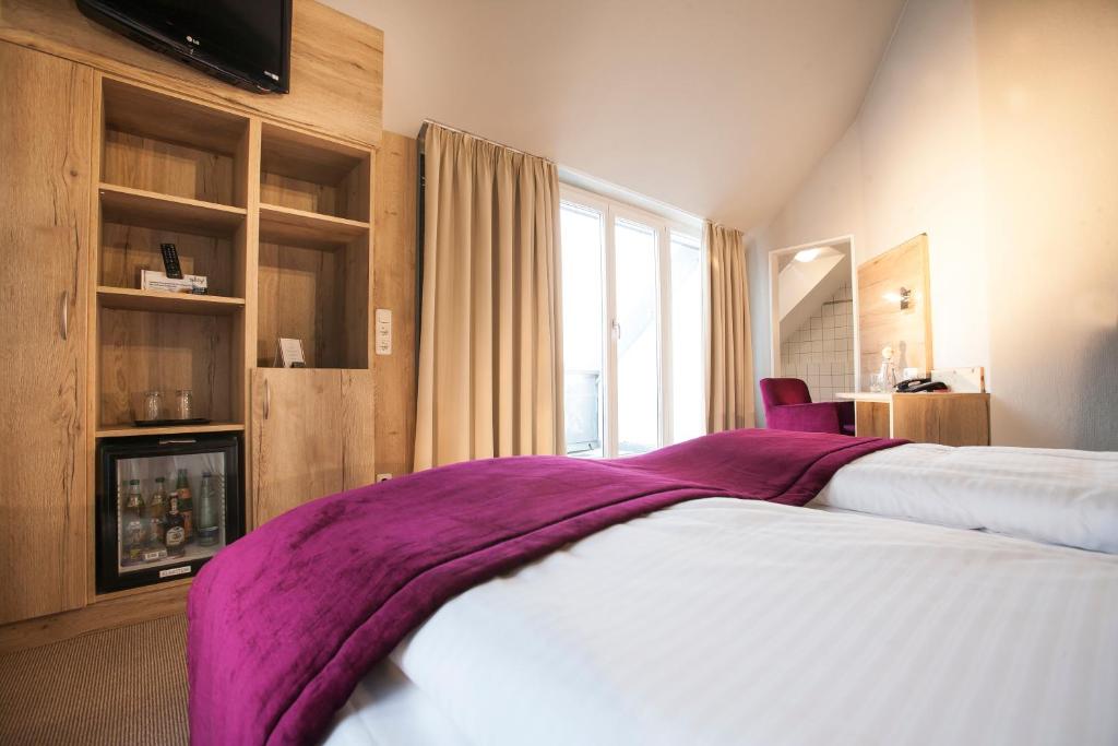Postel nebo postele na pokoji v ubytování Amalienburg - Boutique & Boarding Hotel