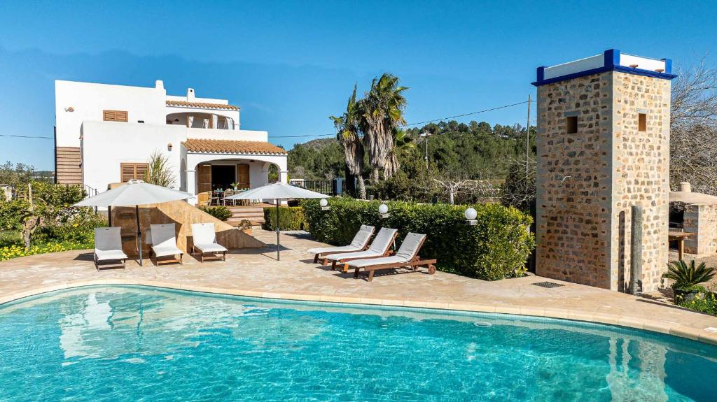 a swimming pool in front of a house at Villa Musset in Can Furnet