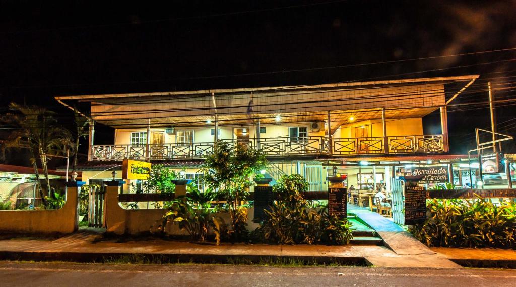 a building with a balcony on the side of it at Hotel Posada Los Delfines in Bocas Town