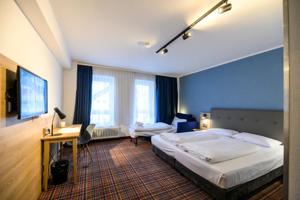 Postel nebo postele na pokoji v ubytování Hotel Ambassador Essen