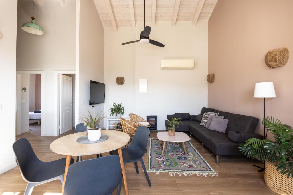 a living room with a couch and a table at בגג העמק On the roof of the valley in HaZore‘im