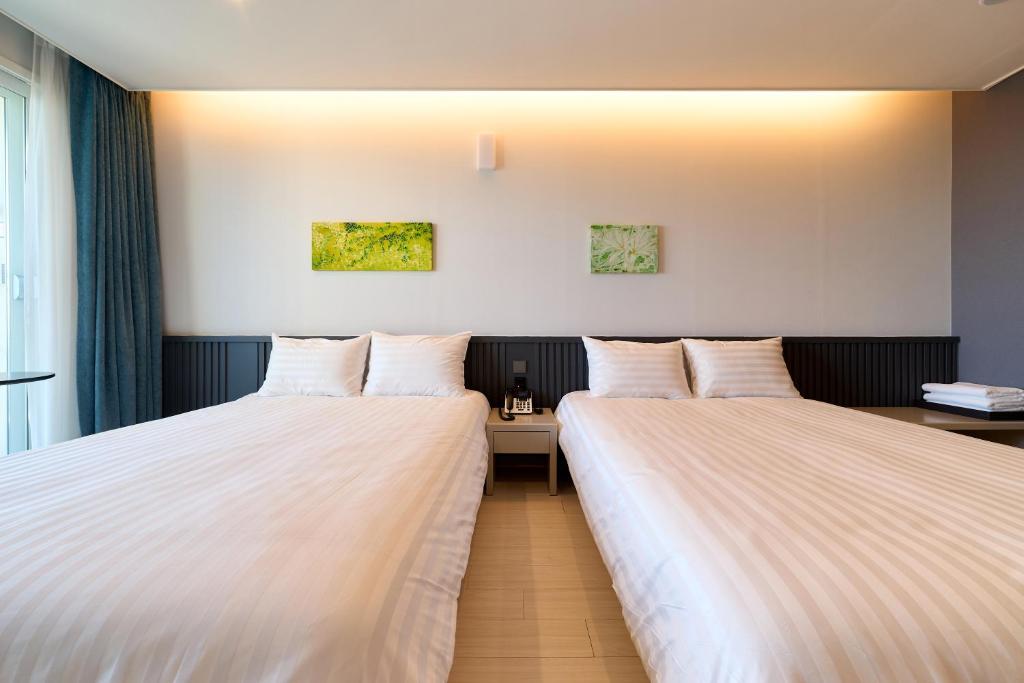 Postel nebo postele na pokoji v ubytování Hotel Sollavue