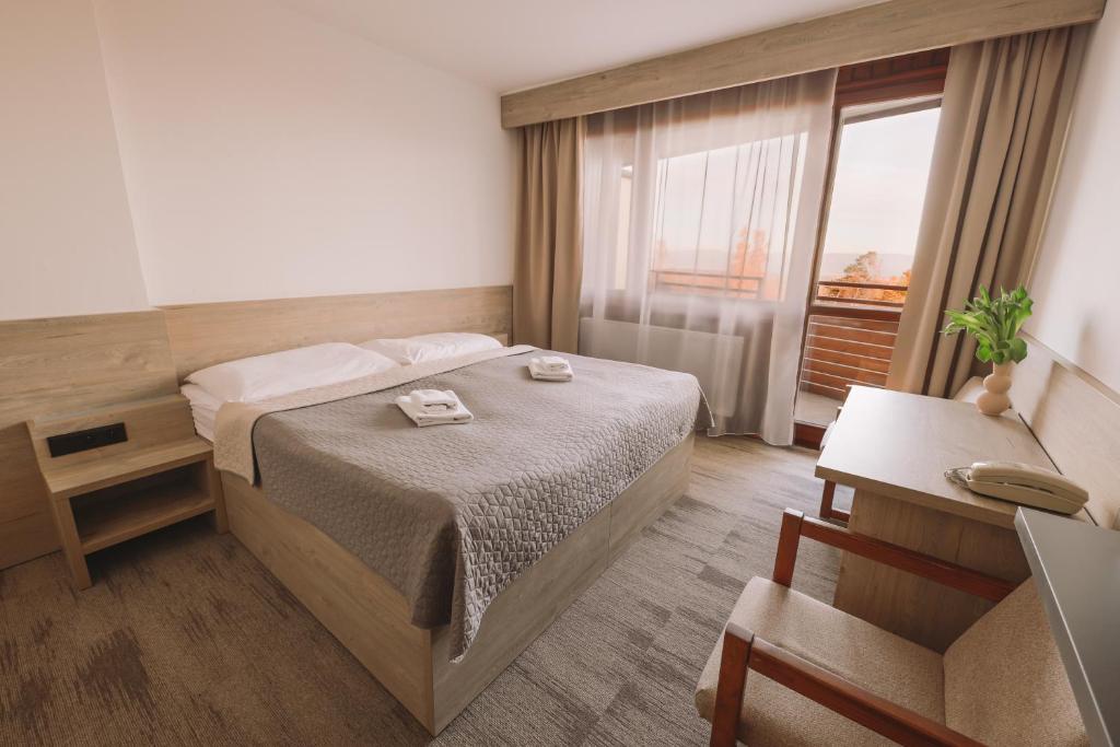 Postel nebo postele na pokoji v ubytování ATLAS Hotel Tatry