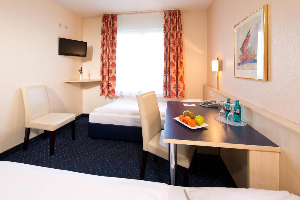 Postel nebo postele na pokoji v ubytování ACHAT Hotel Leipzig Messe