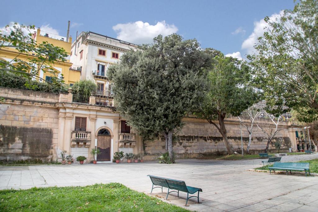 a park bench in front of a building at Palazzo Trinacria in Palermo