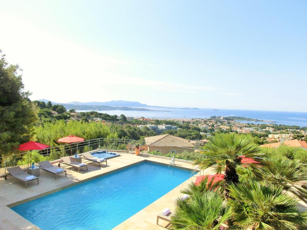 a swimming pool with a view of the ocean at Villa Azur Golf in Bandol