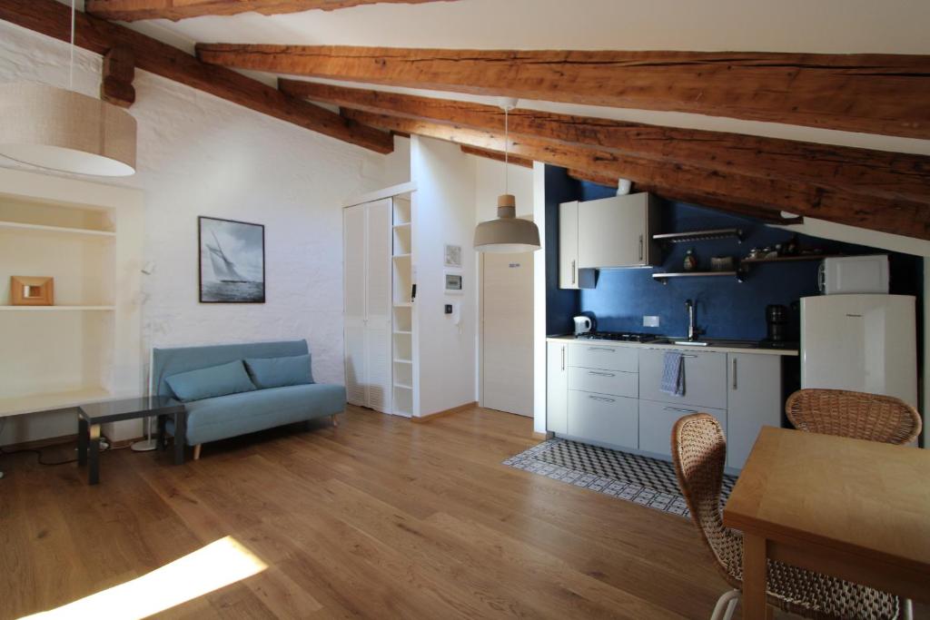 a living room with a blue couch and a table at Alle scalette in Trieste