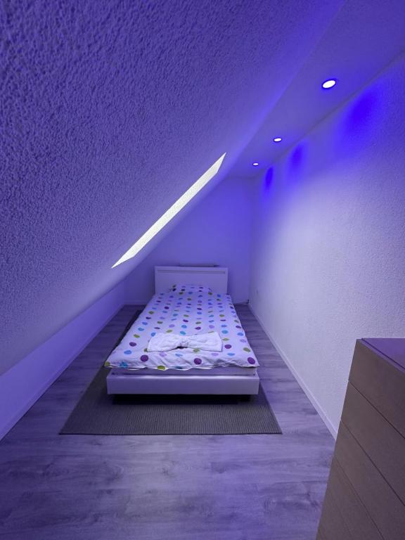 a bed in a room with a purple ceiling at Holiday oasis 120m2 near Legoland Günzburg in Günzburg