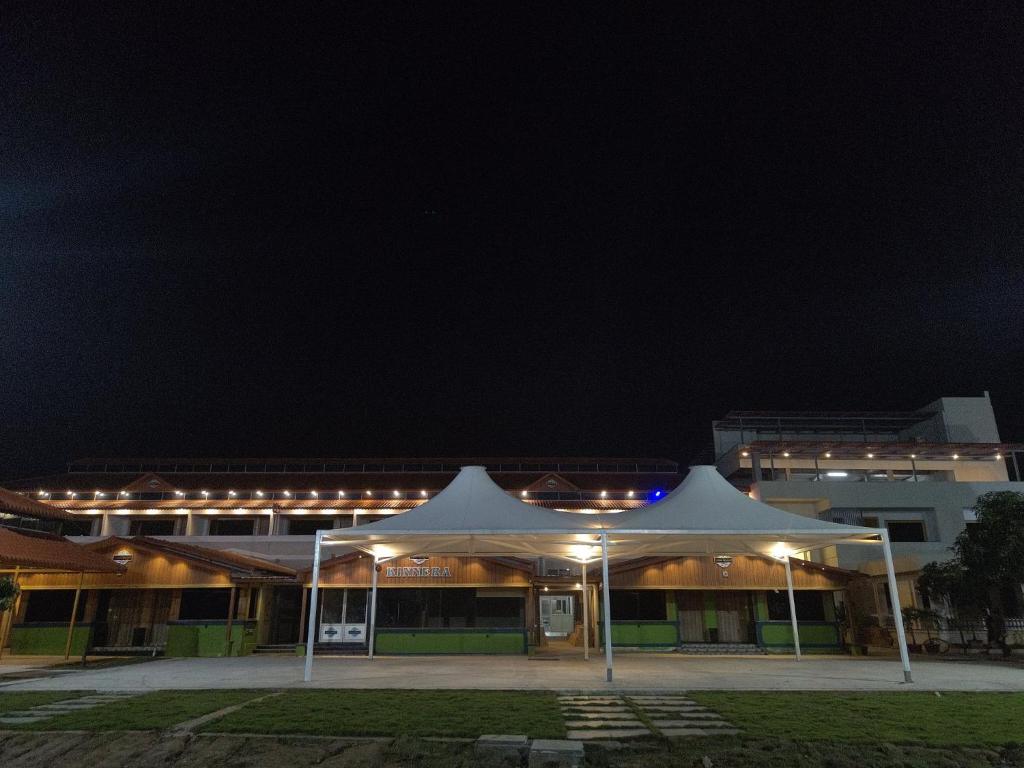 a white tent in front of a building at night at Yanam resorts in Yanam