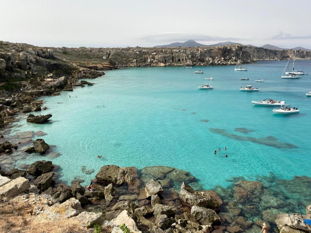 a view of a beach with boats in the water at Al centro con panorama Favignana Isole Egadi in Favignana