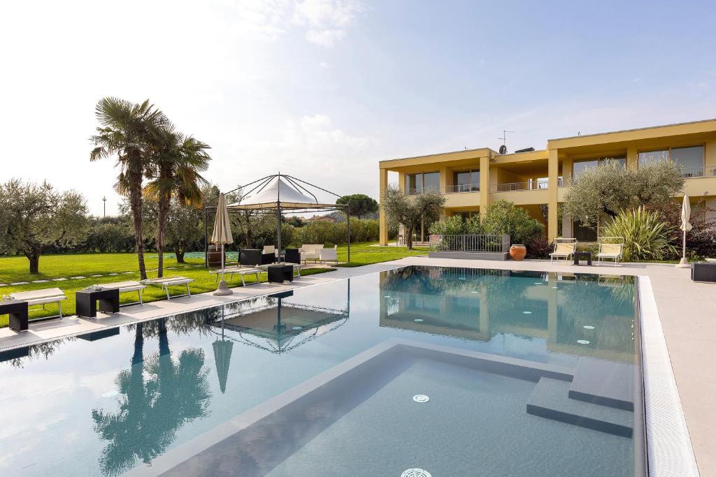 a swimming pool in front of a building at Agriturismo Le Campagnole Green in Bardolino