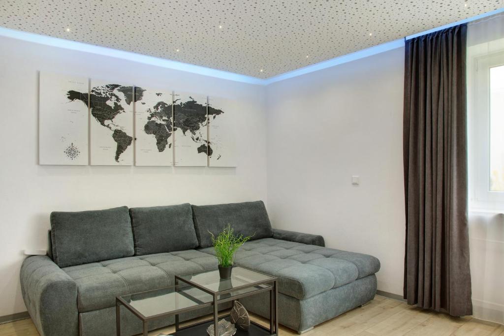 a living room with a couch and a world map on the wall at Modern Apartments Neuburg 2 - New in Neuburg an der Donau