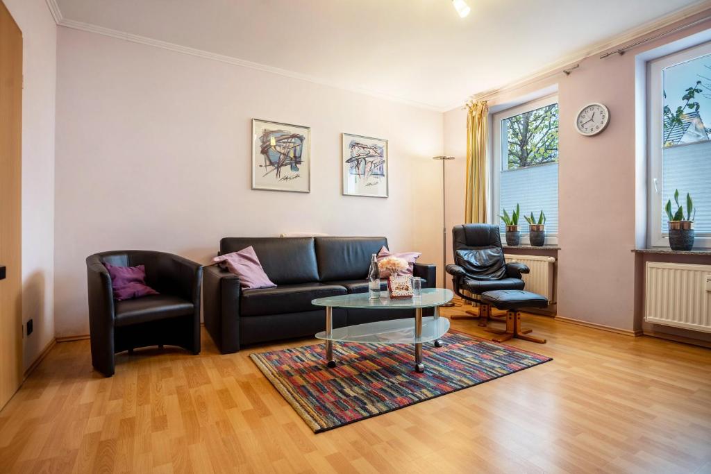 a living room with a couch and a table at Haus Frohsinn - Wohnung 6 in Binz