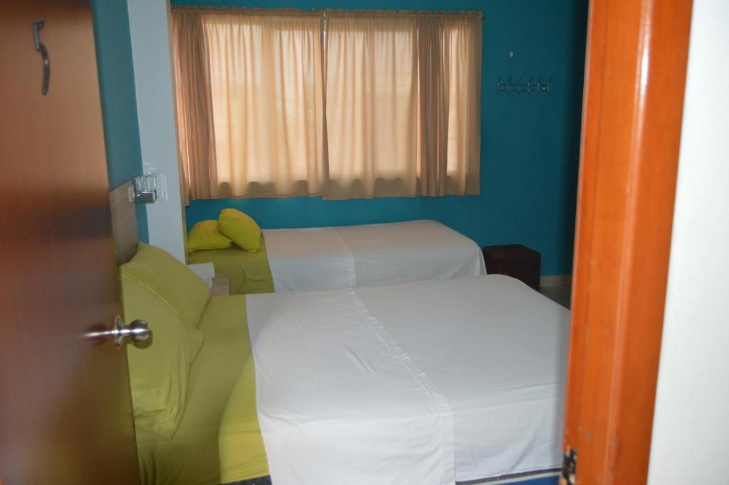 Postel nebo postele na pokoji v ubytování Hostal El Naufrago 1