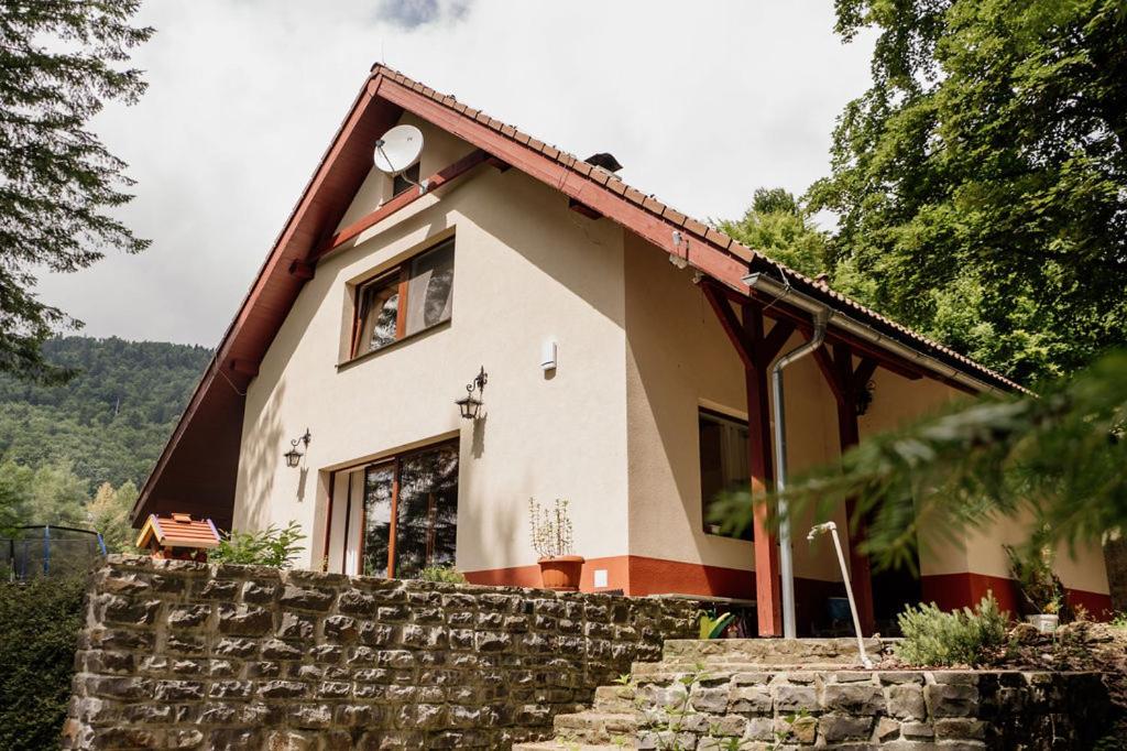 a house with a stone wall in front of it at Chata Hana Donovaly in Donovaly