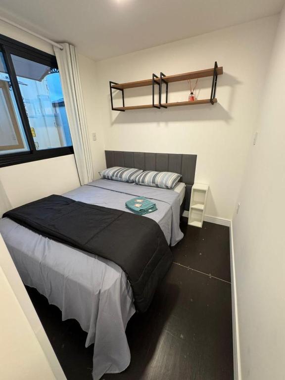 a bedroom with a large bed and a window at House Box 05 in Itapema