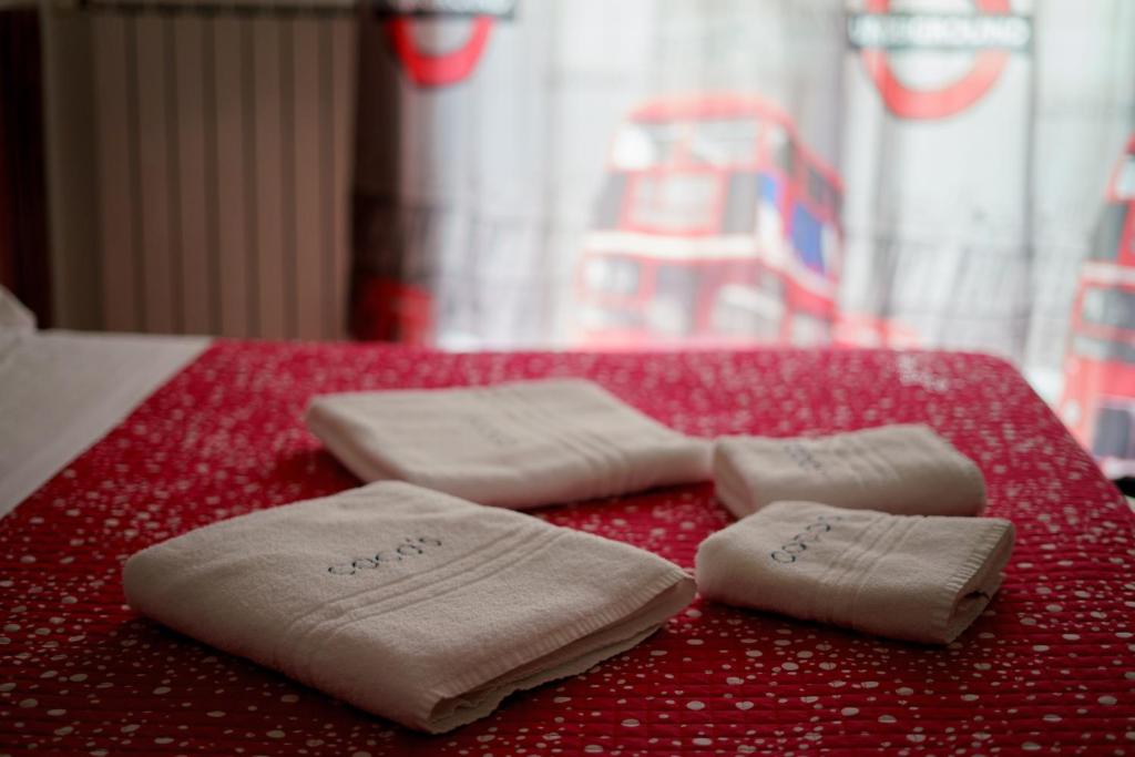 two folded towels sitting on top of a bed at Coco'S Rooms in Bari Palese