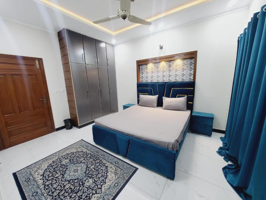 a bedroom with a bed and a window and a door at Kashees Lodges in Islamabad