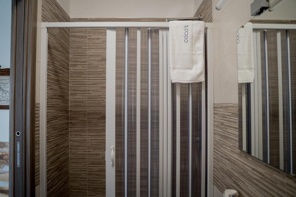 a shower with a sliding glass door in a bathroom at Coco'S Rooms in Bari Palese
