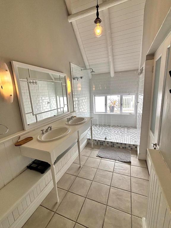 a bathroom with two sinks and a large window at Riptide at no 14 in Sea Vista