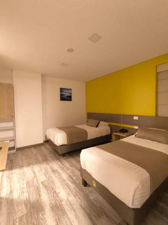 Postel nebo postele na pokoji v ubytování HM HOTEL Expo Inn