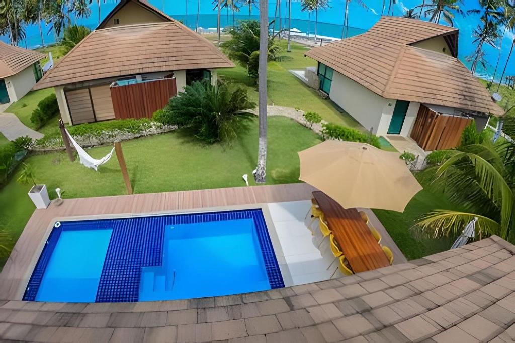 an aerial view of a house with a swimming pool at Bangalo Luxo Praia dos Carneiros Beach Resort in Praia dos Carneiros