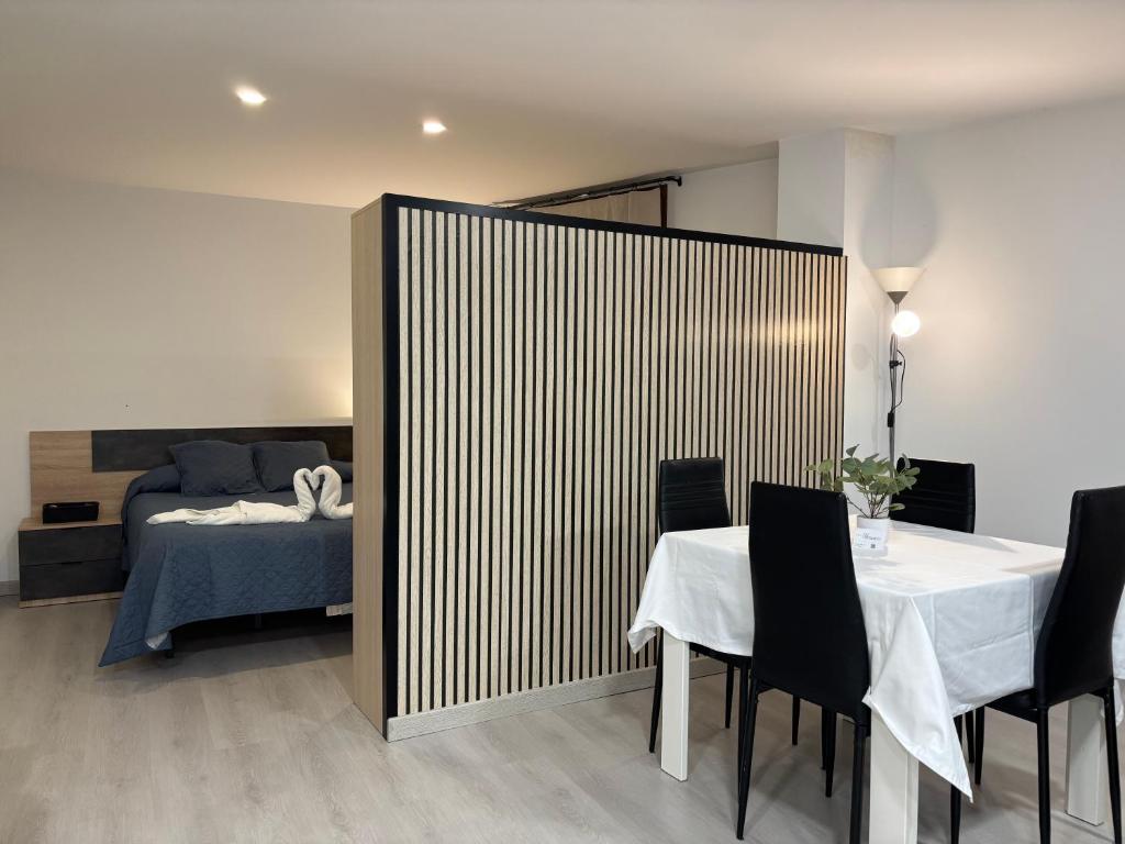 a room with a bed and a table and chairs at Apartament Gritella ( Cim Apartaments ) in Cornudella