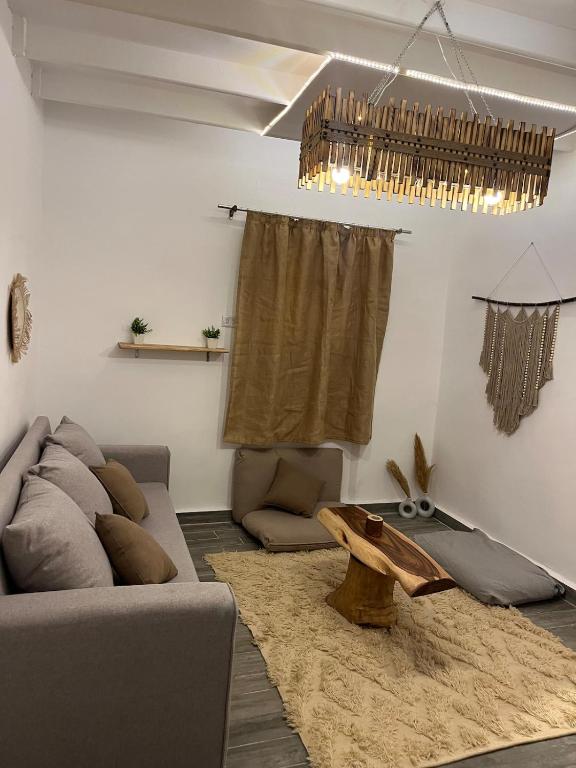 a living room with a couch and a table at Ge boho house in Dahab