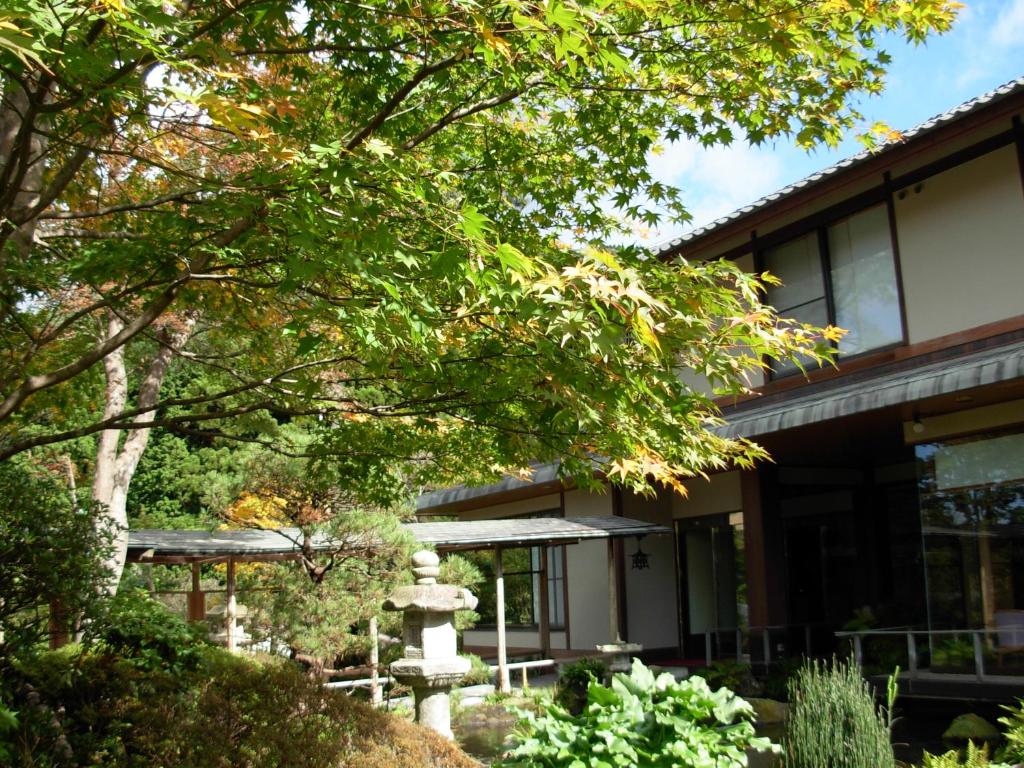 a building with a tree in front of it at Yoshimatsu in Hakone