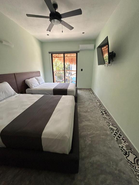 Postel nebo postele na pokoji v ubytování Hotel Mariel Holbox