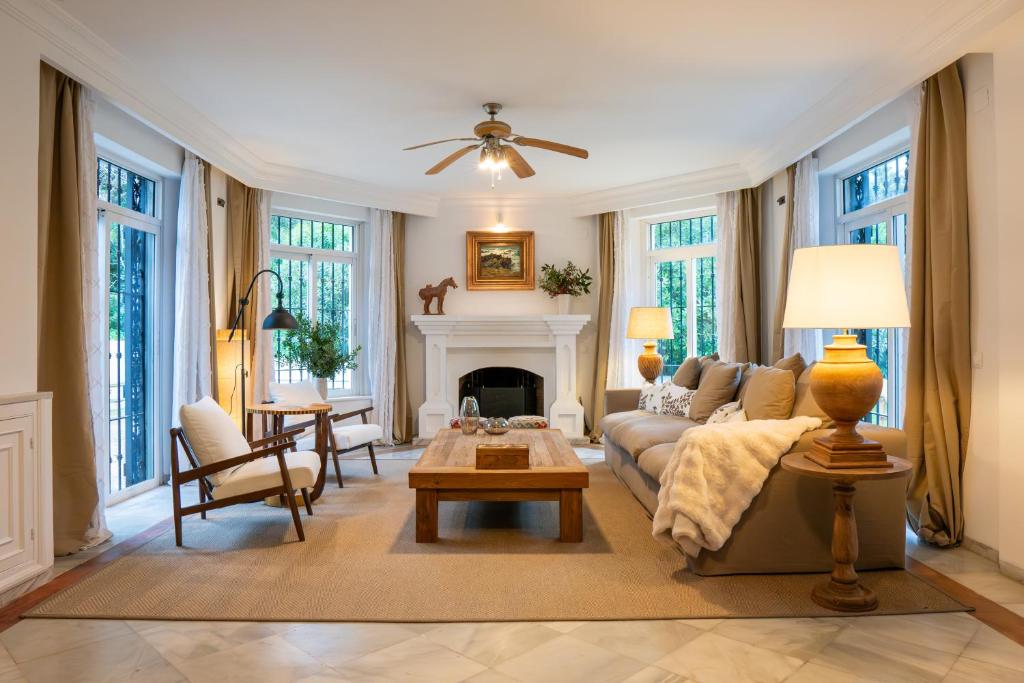 a living room with a couch and a fireplace at La Pinta Golf Villa Sotogrande in Sotogrande