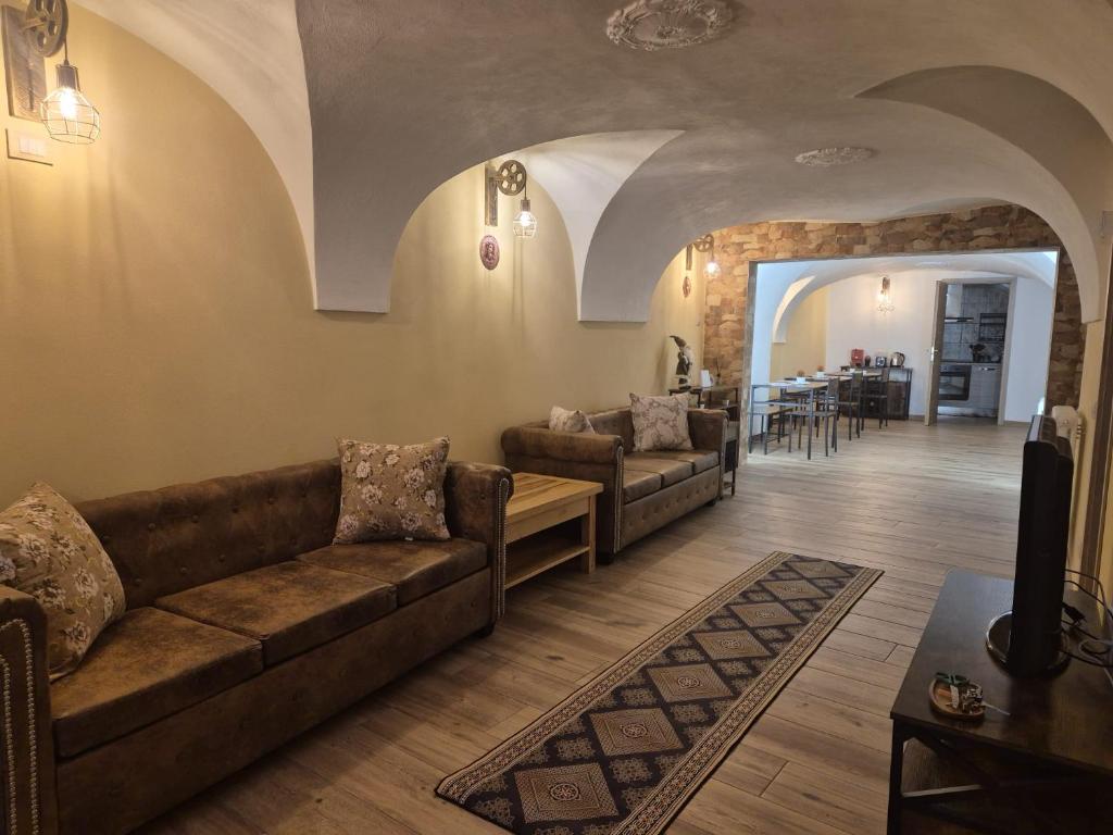 a living room with couches and a dining room at Casa Regina 21 - Families & Friends Dolomites in Ponte delle Arche