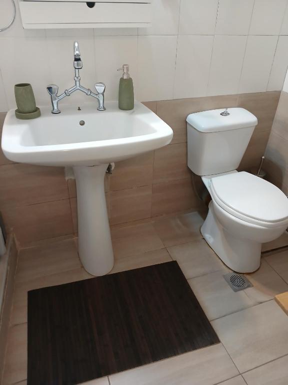 a bathroom with a white sink and a toilet at Athina in Thessaloniki
