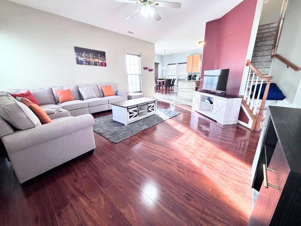 a living room with a couch and a tv at Amazing 4 BDRM home w garage in Charlotte in Charlotte