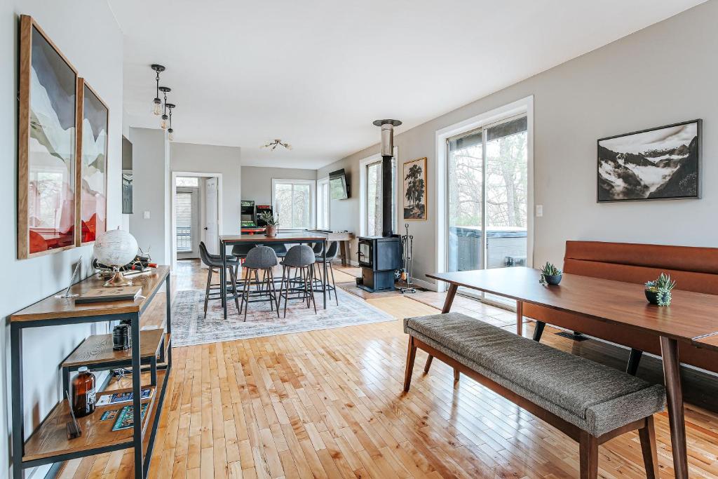 a living room with a couch and a table at Two Forest Cabins,Decks,Fire Pit,Hot Tubs,GameRoom in Berkeley Springs
