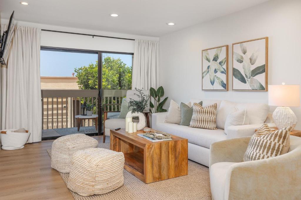 a living room with a white couch and a table at Ocean Whisper - SBTC238 in Solana Beach