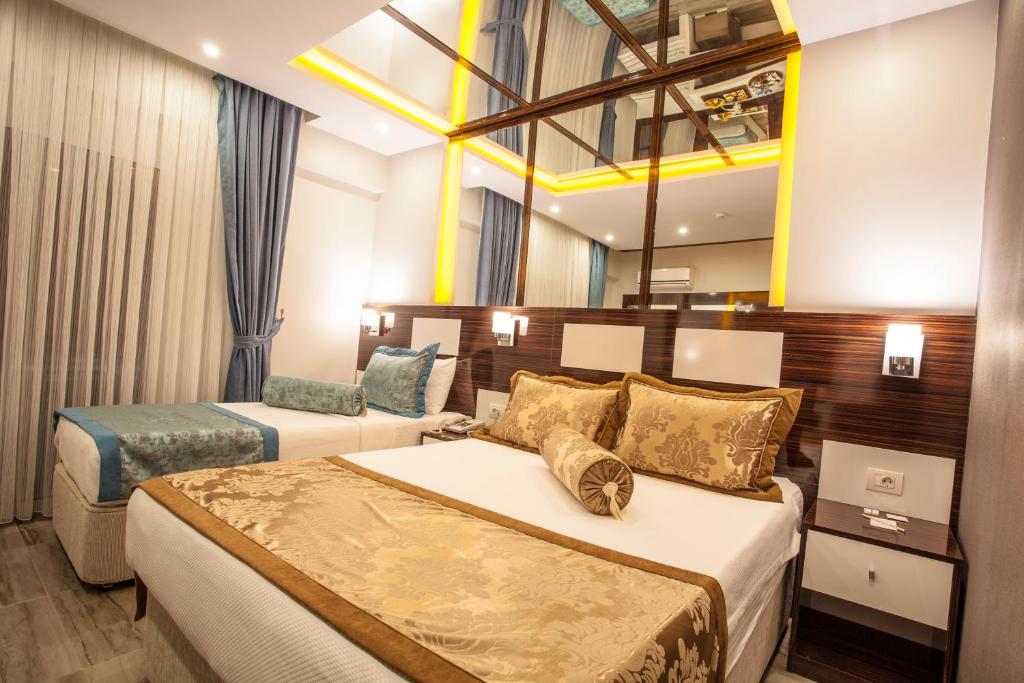Postel nebo postele na pokoji v ubytování Pamukkale Termal Ece Otel