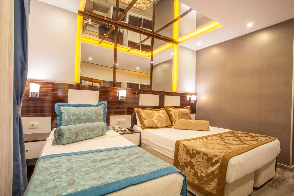 Postel nebo postele na pokoji v ubytování Pamukkale Termal Ece Otel